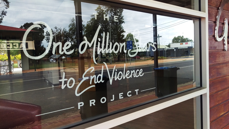 White vinyl lettering on business window